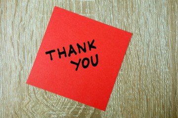 Thank you text written on red sticker