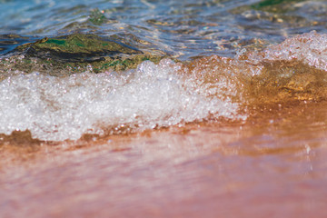 Closeup photo of sea waves rolling on the sandy sea beach. bokeh background.
