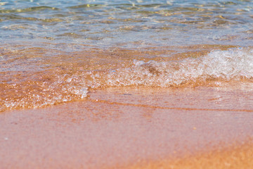 Closeup photo of sea waves rolling on the sandy sea beach. bokeh background.