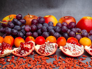 mix of fresh fruits and berries, rich with resveratrol raw food ingredients. nutrition background, red fruits