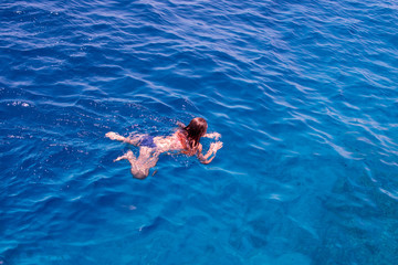 Snorkeling gear.  Snorkeling girl in  full face mask. Underwater swimming in Red sea near a coral reef. Tropical vacation activity snorkeling