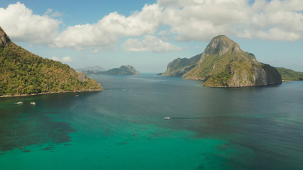 aerial view Seascape with tropical bay, rocky islands, ocean blue water. islands and mountains covered with tropical forest. El nido, Philippines, Palawan. Tropical Mountain Range