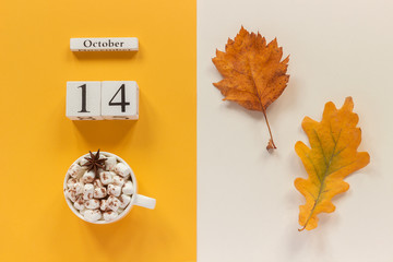 Autumn composition. Wooden calendar October 14, cup of cocoa with marshmallows and yellow autumn leaves on yellow beige background. Top view Flat lay Mockup Concept Hello September