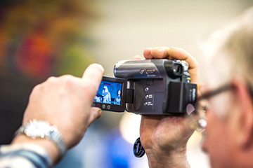 Man filming on video camera