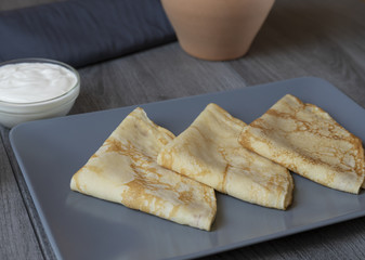 Pancakes folded triangle on a gray plate