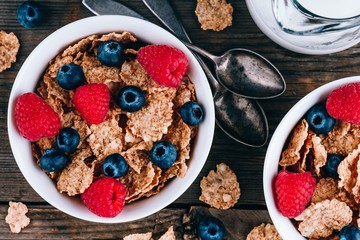 Whole Grain healthy cereals with fresh blueberries and raspberries for breakfast. - Powered by Adobe