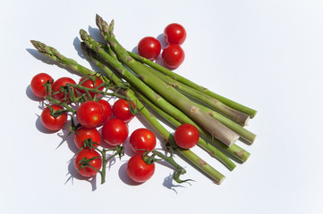 Set of uncooked cherry tomatoes and asparagus