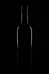 Isolated bordeaux wine bottle, dark background silhouette