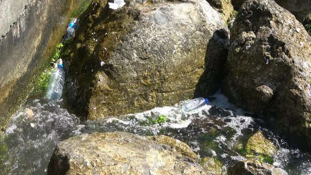 Plastic Trash In Ocean is a fine stock video that exhibits footage of plastic bottles thrown by people into the ocean