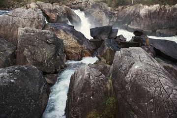 Obraz premium River and waterfall with stones in Norway