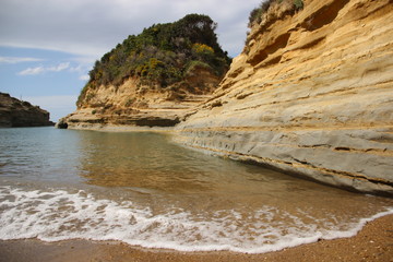 Little Bay With Colorful Million Years Stone Layer And Steep cliff In Sidari Corfu Island  Greece