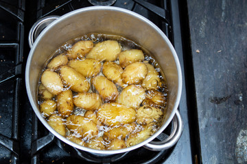 Jersey royal potatoes cooking in boiling water in a large saucepan