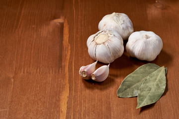 Garlic and garlic cloves on wooden background. Selective focus