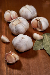 Garlic and garlic cloves on wooden background. Selective focus