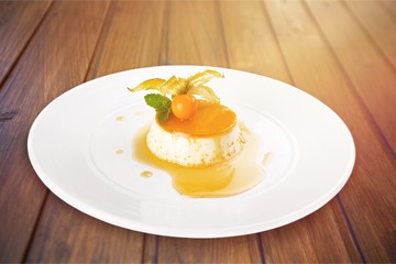 Caramel custard with cream and  topping.