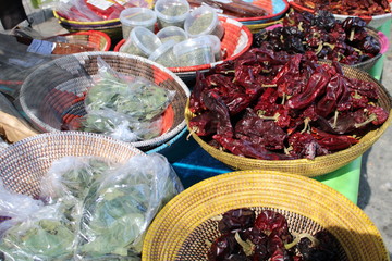 Baskets with dried peppers and other species