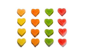 Set of heart shaped marmalade jelly candies, isolated on white background. Closeup, top view, soft selective focus.