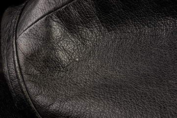 Old vintage genuine soft black leather texture background, top layer with pores and scratches,...