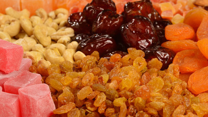 Mix of nuts and dried fruits and sweet turkish delights background.