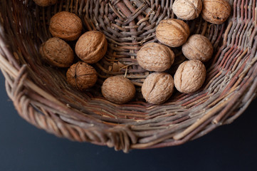walnuts in a basket on a dark background