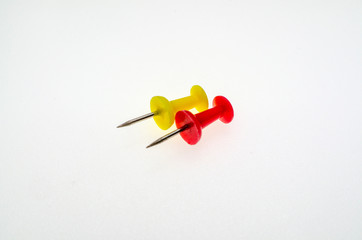 Red and yellow stationery buttons close-up on white background without shadow - 270270239