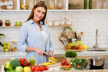 Obraz na płótnie Canvas Cooking Vegetable Salad. Happy Woman Cutting Pepper
