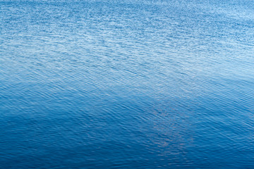 Water surface. Light ripples on the surface of the water.