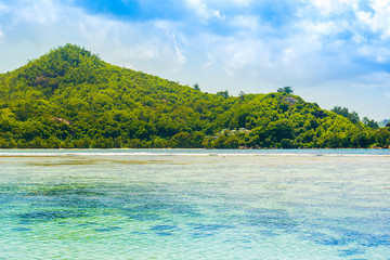 Beautiful tropical landscape with green hills on the shores of the Indian Ocean