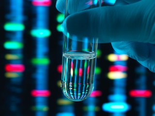 Genetic Research, DNA profile reflected in a test tube containing a sample