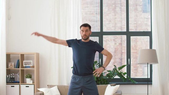 fitness, sport and healthy lifestyle concept - man exercising and leaning at home