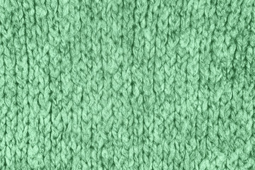 Loose Knitwear Fabric Texture with wool fibers. Repeating Machine Knitting Texture of warm Sweater. Trendy mint colored Knitted Background.
