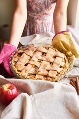Set up, layout or still life with home made apple pie on table covered with light tablecloth on...