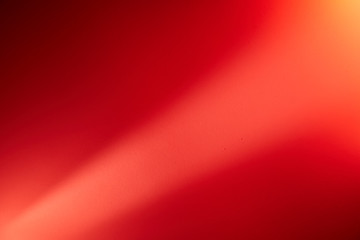 Light red ray of light on a red blurred background