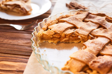 Tasty homemade apple pie. American pie. Apples. Cinnamon. Plate. Linen towel. Wooden background. Top view