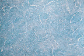 Grunge background or texture - uneven worn surface of the plastered wall