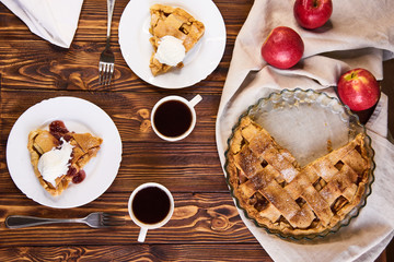 Tasty homemade apple pie, slice with ice cream. Apples. Plate, linen towel Wooden background Top view