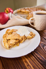 A finished plate and spoon, after eating apple pie a la mode. Part of a series of images showing the preparation of traditional apple pie.