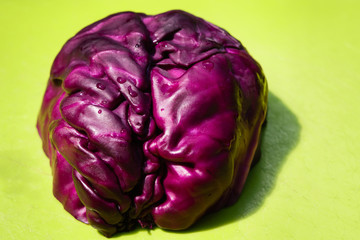 Close-up of red cabbage on green platic cutting board. Bright healthy vegan food