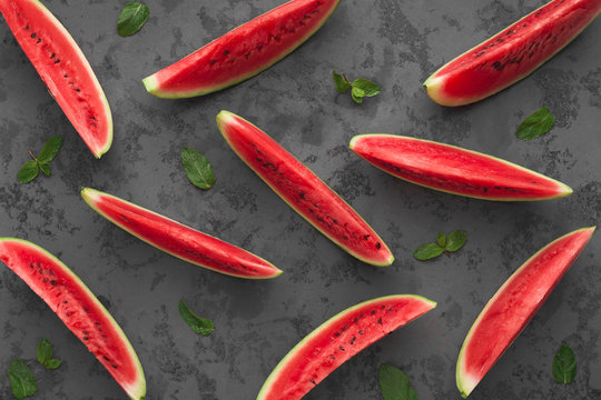 Red watermelon slices on dark grey background