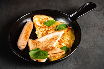 omelet with toasts and sausage