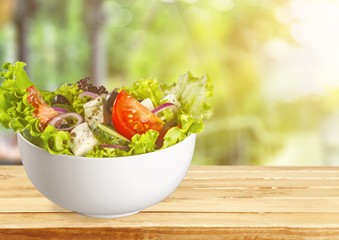 Close-up photo of fresh salad with vegetables in white plate