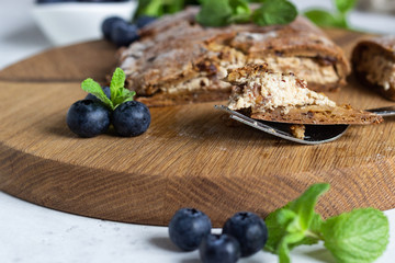 Gluten free hand pies with cottage cheese filling without sugar with fresh blueberries and mint.  Healthy dessert, pastry.