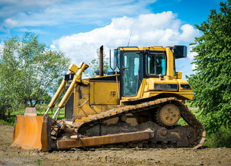 Old Yellow Bulldozer on blue sky