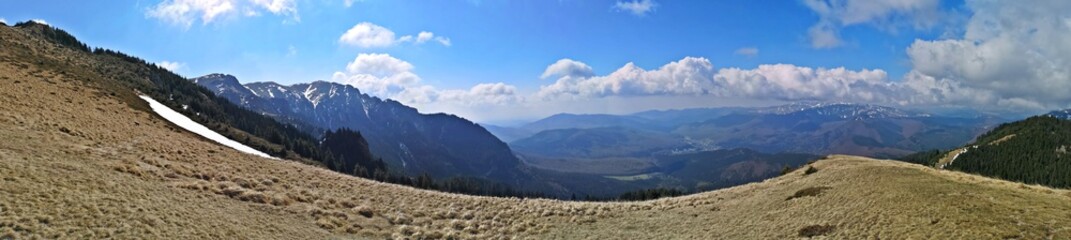 Panoramic mountains landscape in early spring - snow in the mountains 