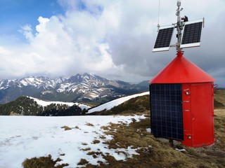 Solar panels mounted on a shelter roof and walls in the high mountains. 