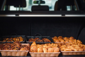 Fresh croissants basket into the car 