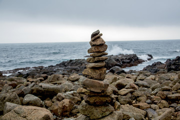 Fototapeta na wymiar Cairn in front of coastal landscape
