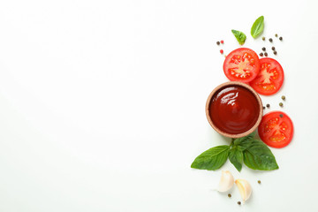 Flat lay composition with fresh cherry tomatoes slices, basil, pepper, garlic and sauce on white background, space for text. Ripe vegetables