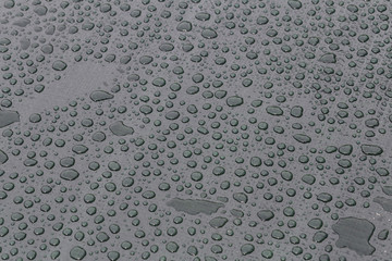 Large drops of water on plastic film after rain