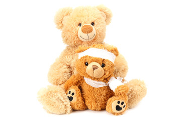 Two toy teddy bears with bandage isolated on white background